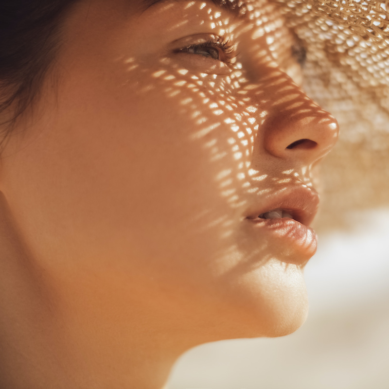 young woman in large straw hat